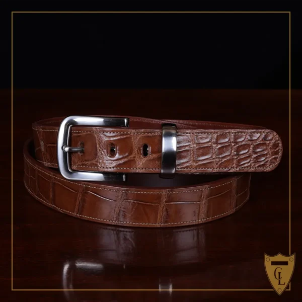 No. 4 Belt in American Alligator - X-Large - ID 001 - coiled front view on a wooden table with black background