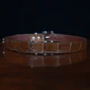 An American Alligator Belt with Nickel hardware showing the back view on a wooden table with black background - id 001