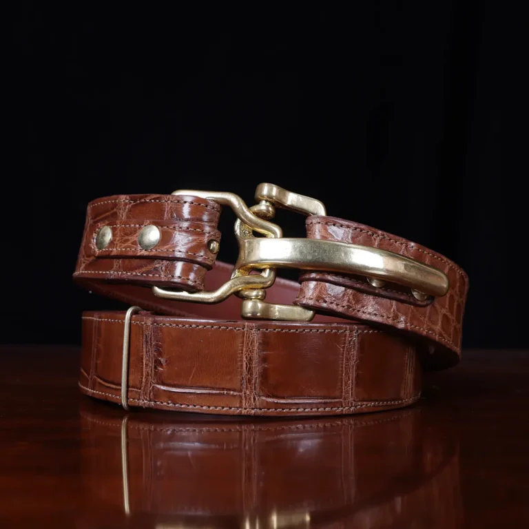 No. 5 Cinch Belt in brown American Alligator and brass buckle - ID 002 - coiled view on black background