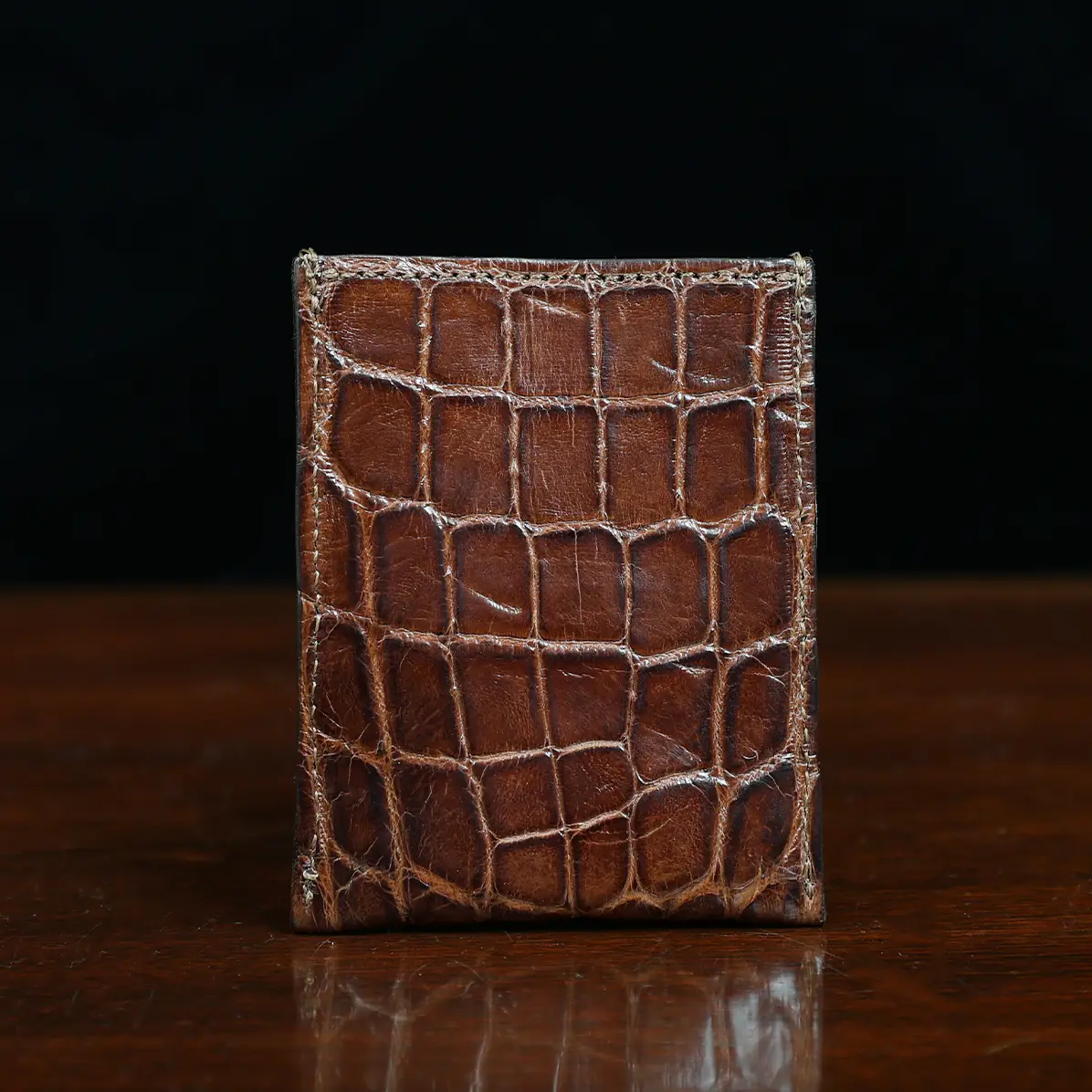 View larger image of No. 4 Card Case in Vintage Brown American Alligator - ID 001 - front view cut out on No. 2 Card Wallet in Vintage Brown American Alligator - ID 001 - back view on a black background