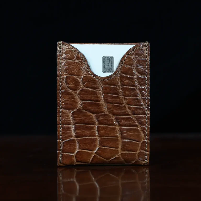 No. 4 Card Case in Vintage Brown American Alligator - ID 001 - front view cut out on No. 2 Card Wallet in Vintage Brown American Alligator - ID 001 - front view with card on a black background