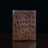 No. 4 Card Case in Vintage Brown American Alligator - ID 002 - back view on a wood table and dark background