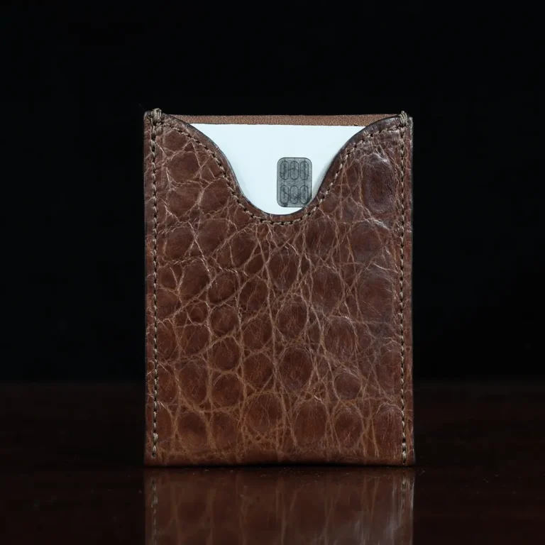 No. 4 Card Case in Vintage Brown American Alligator - ID 002 - front view with cardon a wood table and dark background