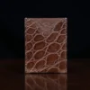 No. 4 Card Case in Vintage Brown American Alligator - ID 002 - front view on a wood table and dark background