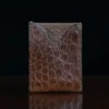 No. 4 Card Case in Vintage Brown American Alligator - ID 002 - front view on a wood table and dark background