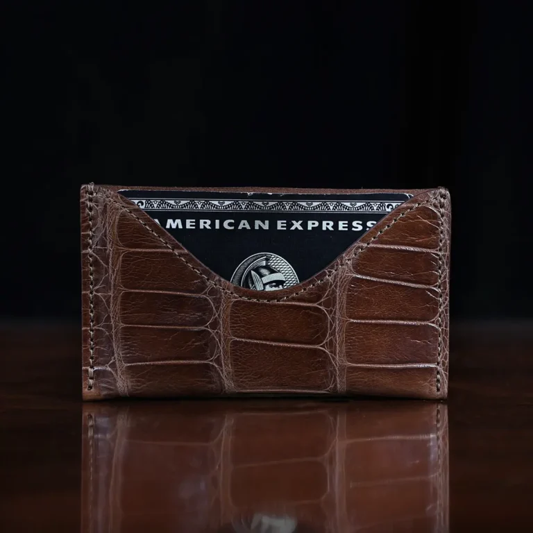 No. 3 Card Wallet in Vintage Brown American Alligator - ID 001 - front view cut out on No. 2 Card Wallet in Vintage Brown American Alligator - ID 001 - front view with card on a black background
