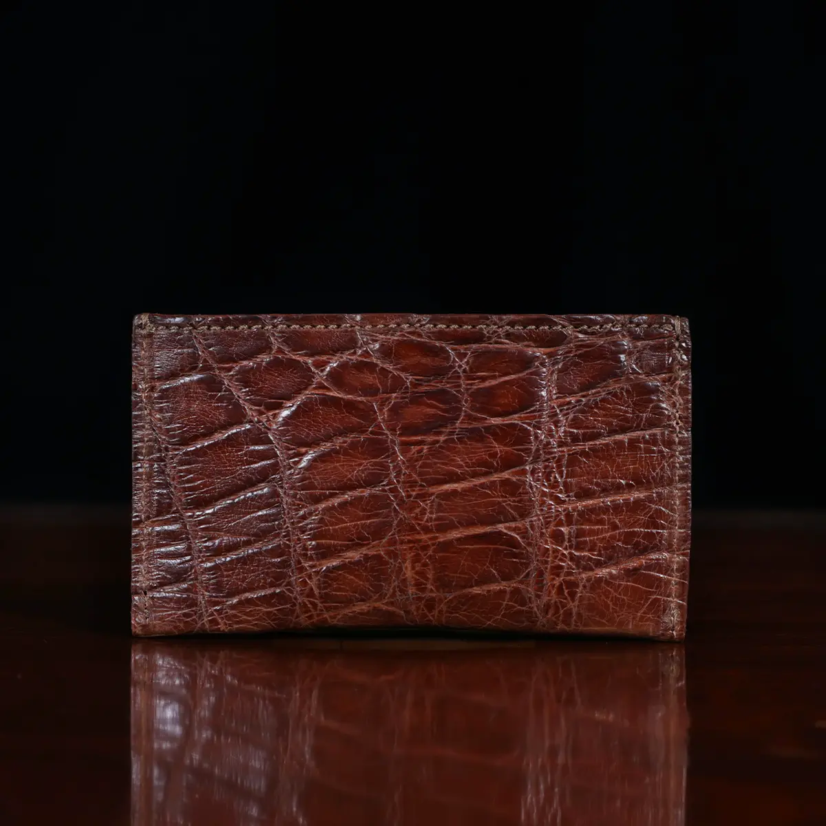 No. 3 Card Wallet in Vintage Brown American Alligator - ID 003 - front view with business card cut out on No. 2 Card Wallet in Vintage Brown American Alligator - ID 003 - back view on a black background