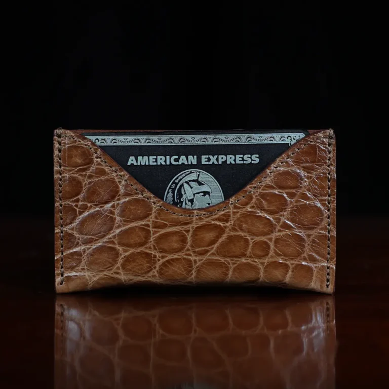 No. 3 Card Wallet in Vintage Brown American Alligator - ID 003 - front view with business card cut out on No. 2 Card Wallet in Vintage Brown American Alligator - ID 001 - front view with card on a black background