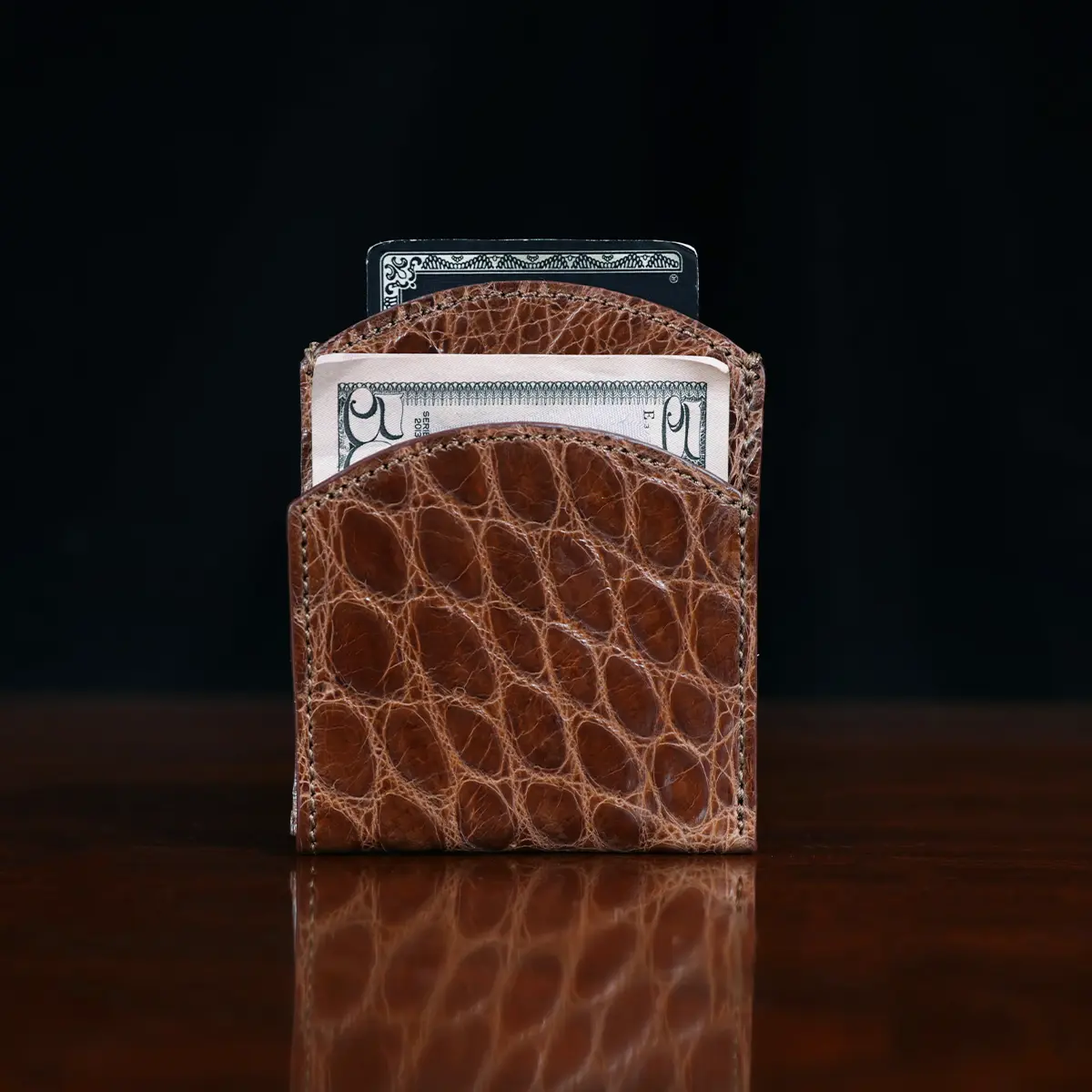 Front pocket wallet in brown American Alligator - ID 002 - front view with money on black background