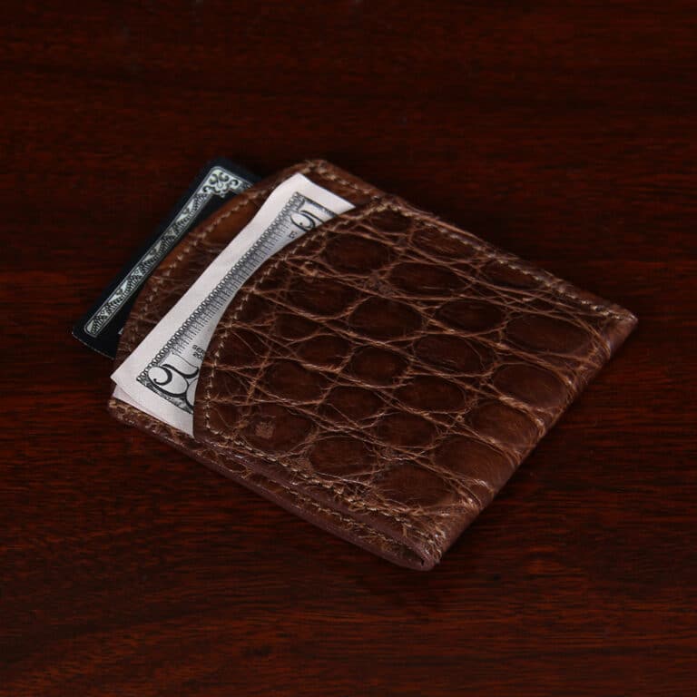 Front pocket wallet in brown American Alligator - ID 002 - laying down with money view on black background