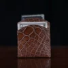 Front pocket wallet in brown American Alligator - ID 003 - front view with card and cash on black background