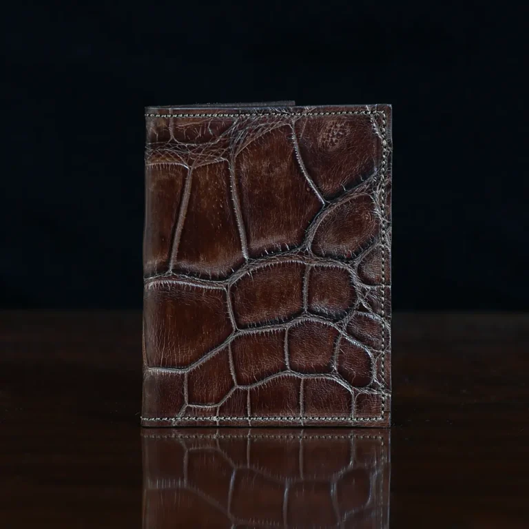 No. 2 card wallet in Vintage Brown American Alligator - ID 001 - front view on a wood table and dark background