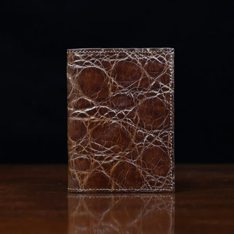 No. 2 card wallet in Vintage Brown American Alligator - ID 001 - front view on a wood table and dark background