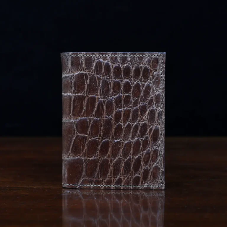 No. 2 card wallet in Vintage Brown American Alligator - ID 001 - front view on a wood table and dark background