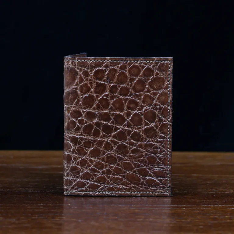 No. 2 card wallet in Vintage Brown American Alligator - ID 001 - front view on a wood table and dark background
