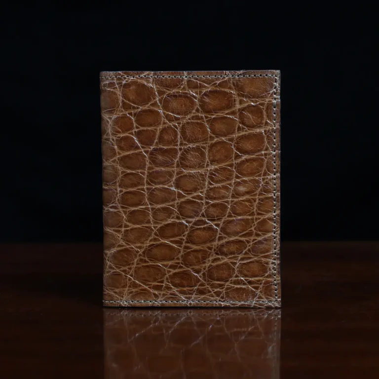 No. 2 card wallet in Vintage Brown American Alligator - ID 001 - front view on a wood table and dark background