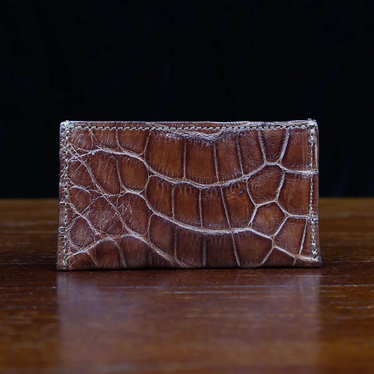 View larger image of No. 3 Card Wallet in Vintage Brown American Alligator - ID 003 - front view with business card cut out on No. 2 Card Wallet in Vintage Brown American Alligator - ID 001 - back view on a black background