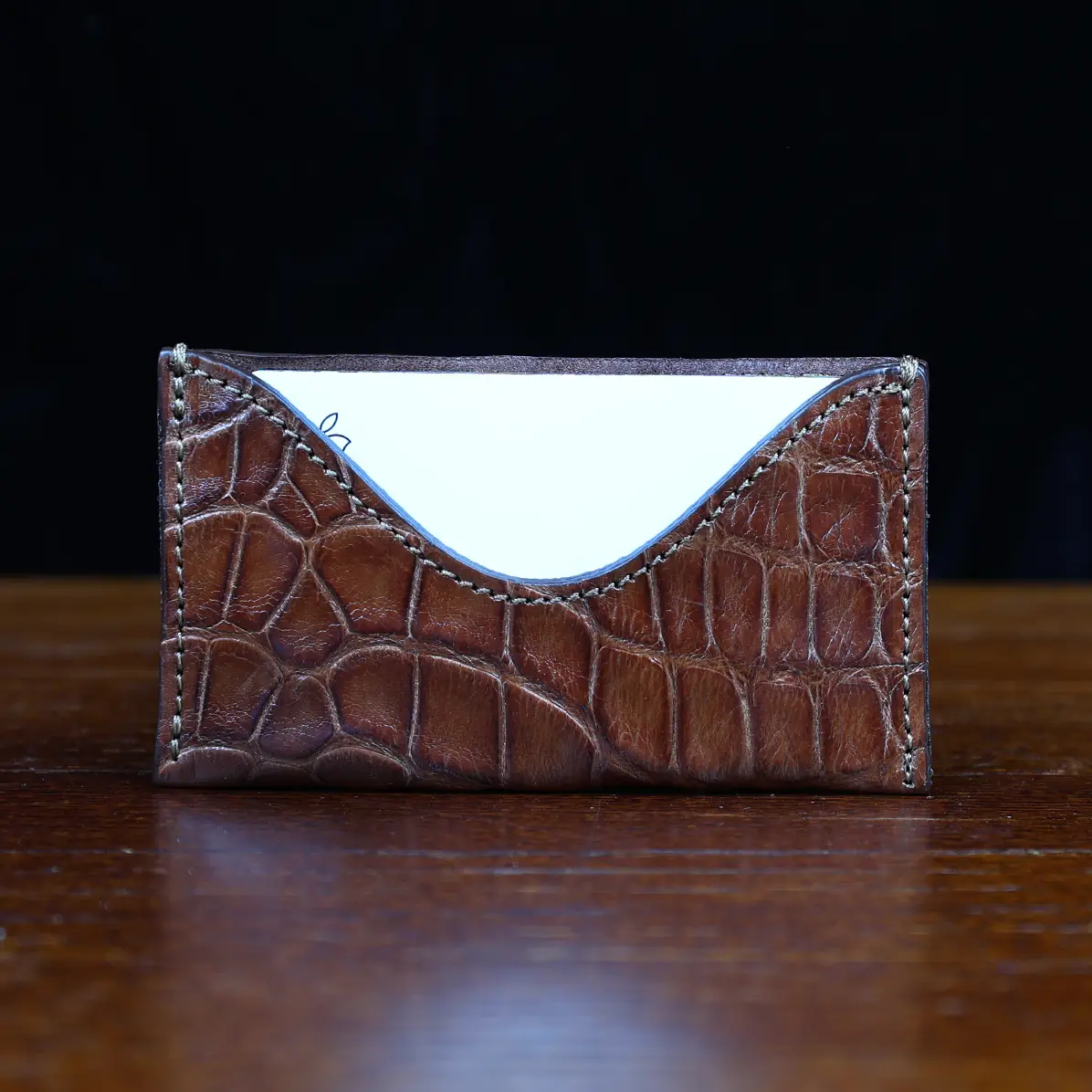 View larger image of No. 3 Card Wallet in Vintage Brown American Alligator - ID 003 - front view with business card cut out on No. 2 Card Wallet in Vintage Brown American Alligator - ID 001 - front view on a black background