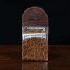 front pocket wallet in american alligator showing the front open with cash and card