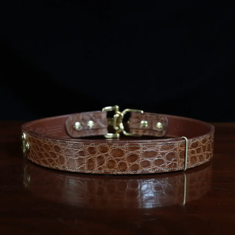 no 5 cinch belt in american alligator - size small- back view on a wood table and dark background - id 002