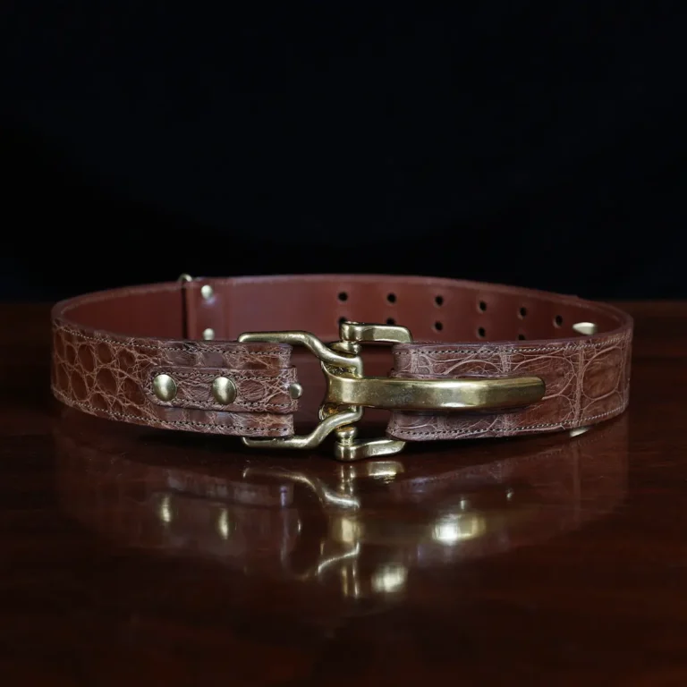 no 5 cinch belt in american alligator - size small- front view on a wood table and dark background - id 002