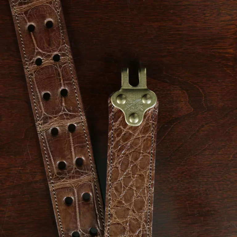 no 5 cinch belt in american alligator - size small- hook view on a wood table and dark background - id 002