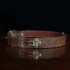 no 5 cinch belt in american alligator - size small- side view on a wood table and dark background - id 002