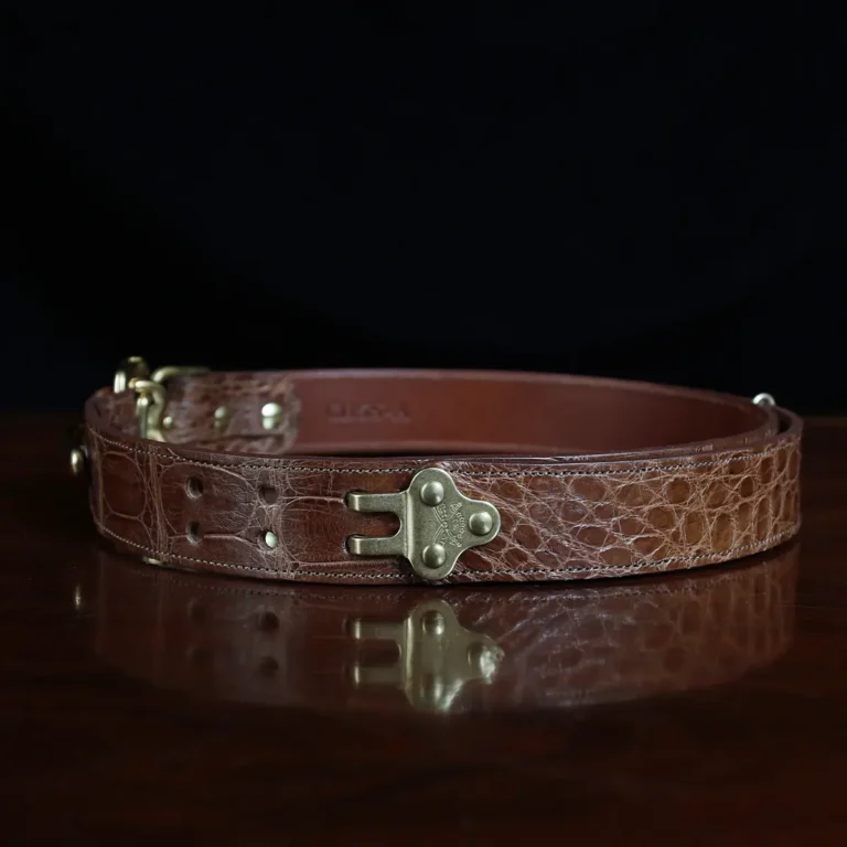 no 5 cinch belt in american alligator - size small- side view on a wood table and dark background - id 002