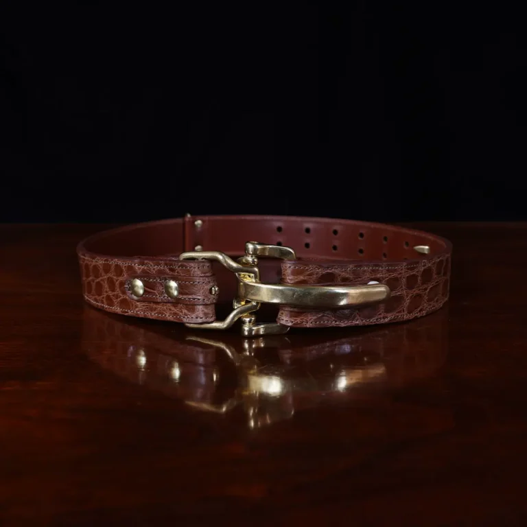 no 5 cinch belt in american alligator - size small- front view on a wood table and dark background - id 002
