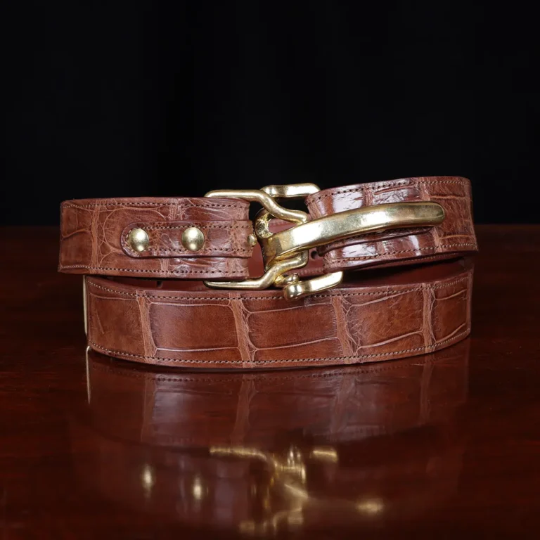 No. 5 Cinch Belt in Vintage Brown American Alligator with Brass hardware - X-Large - ID 001 - coiled front view cut out onNo. 2 Card Wallet in Vintage Brown American Alligator - ID 001 - front view on a black background