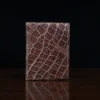 Front pocket wallet with flap in brown American Alligator - back view - 002 - on wood table with a dark background