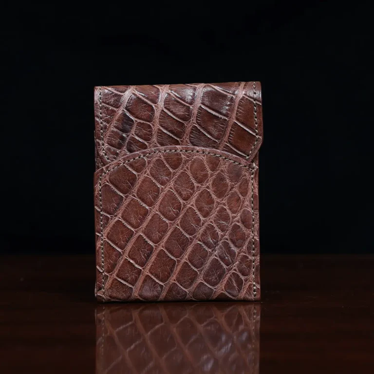Front pocket wallet with flap in brown American Alligator - front view - 002 - on wood table with a dark background
