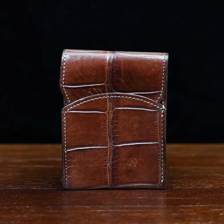 Front pocket wallet with flap in brown American Alligator - front view - 002 - on wood table with a dark background