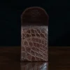 Front pocket wallet with flap in brown American Alligator - front open view - 002 - on wood table with a dark background