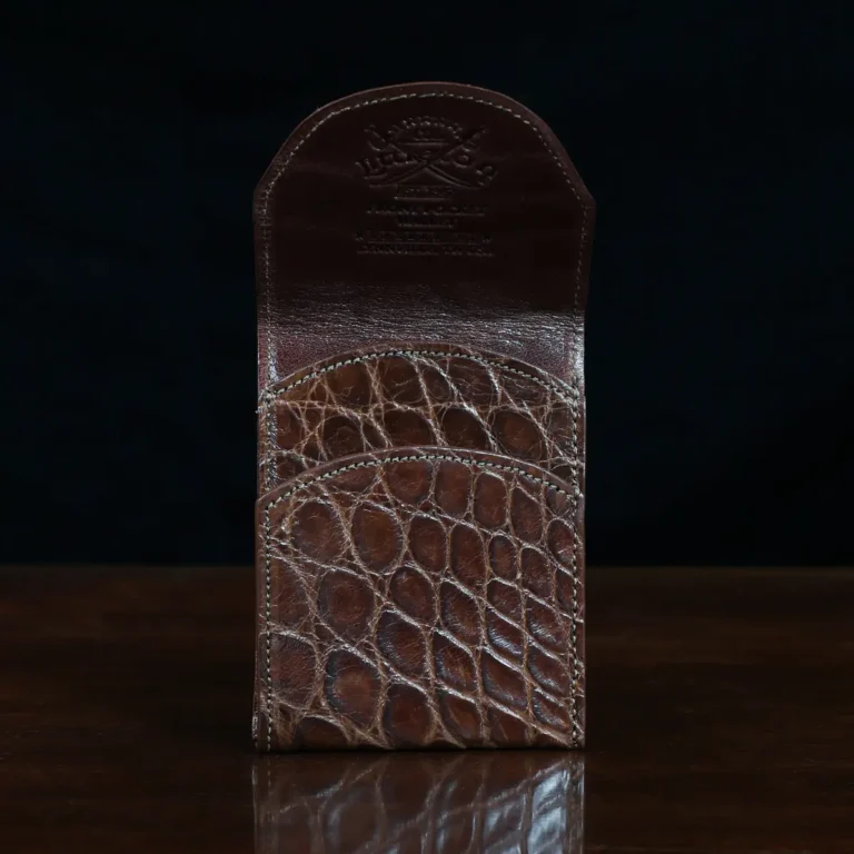 Front pocket wallet with flap in brown American Alligator - front open view - 002 - on wood table with a dark background