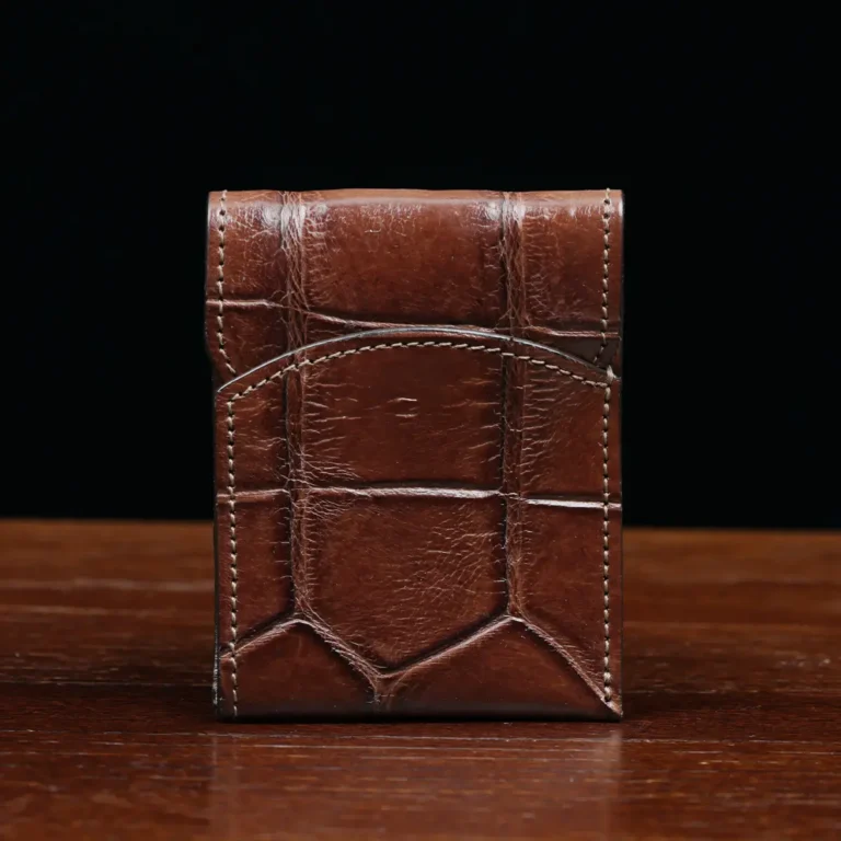 Front pocket wallet with flap in brown American Alligator - front view - 002 - on wood table with a dark background