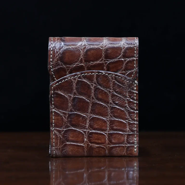 Front pocket wallet with flap in brown American Alligator - front view - 002 - on wood table with a dark background