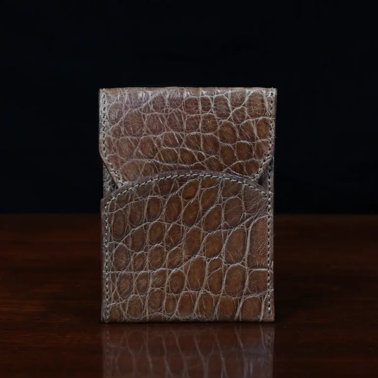 Front pocket wallet with flap in brown American Alligator - front view - 002 - on wood table with a dark background