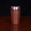 traveler leather tumbler sleeve in 20 oz on wooden table