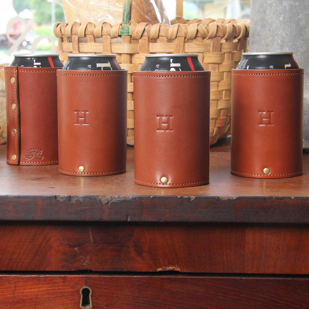 can of coke inside of brown leather can caddies with personalized initial stamp