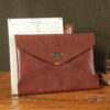 emissary brown american leather document envelope on wooden table