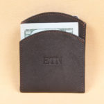 Black leather front pocket wallet front with 3 embossed initials centered.