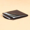 Black leather front pocket wallet top with 3 cards and 2 bills inside pockets.