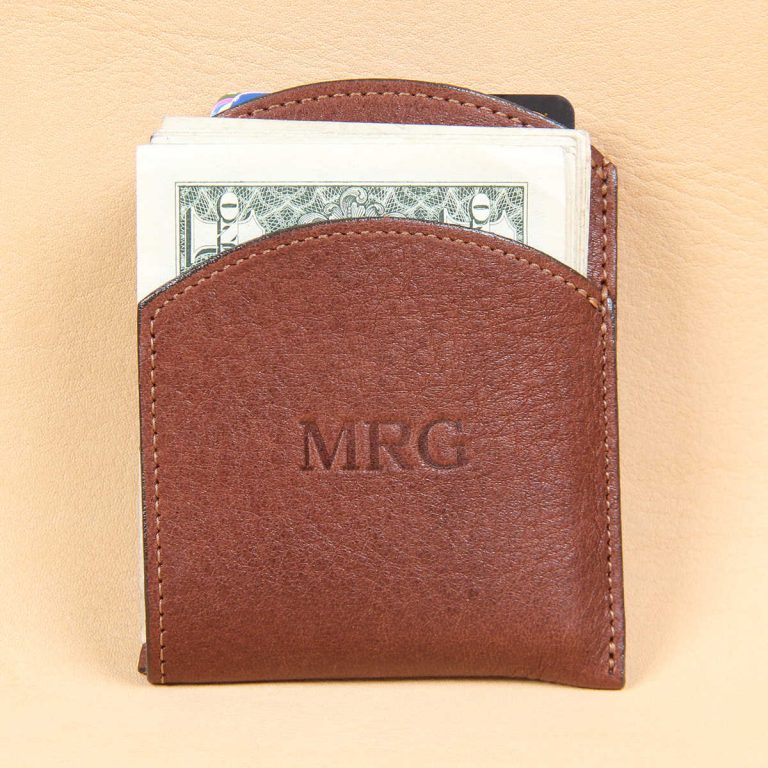Brown leather front pocket wallet front full of 10 bills in front pocket.