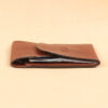 vintage brown leather front pocket wallet with fold over flap with cash