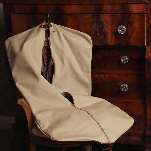 no7 khaki cotton canvas garment bag with brown leather strap and zippered closure