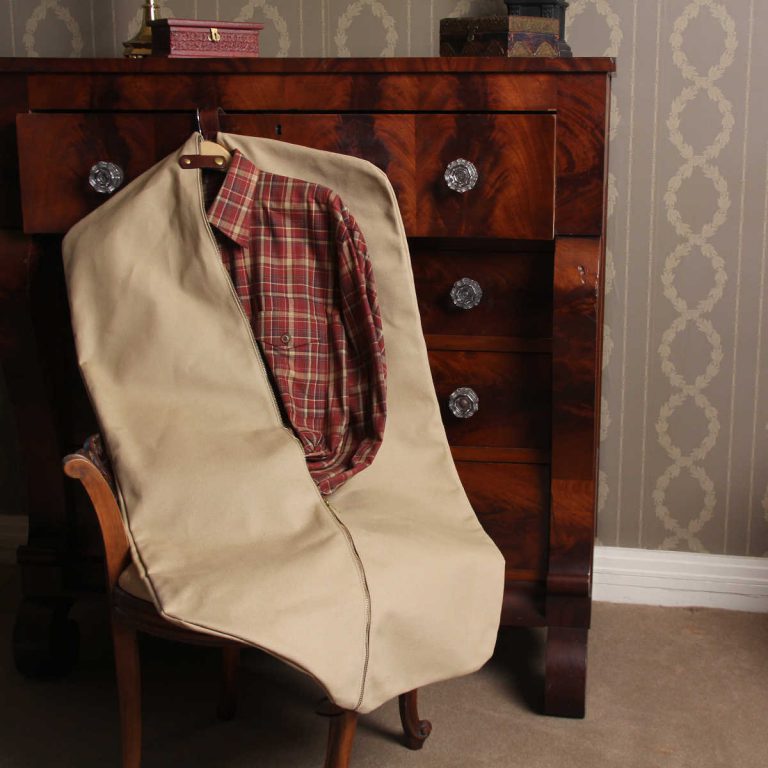 no7 khaki cotton canvas garment bag on wooden chair