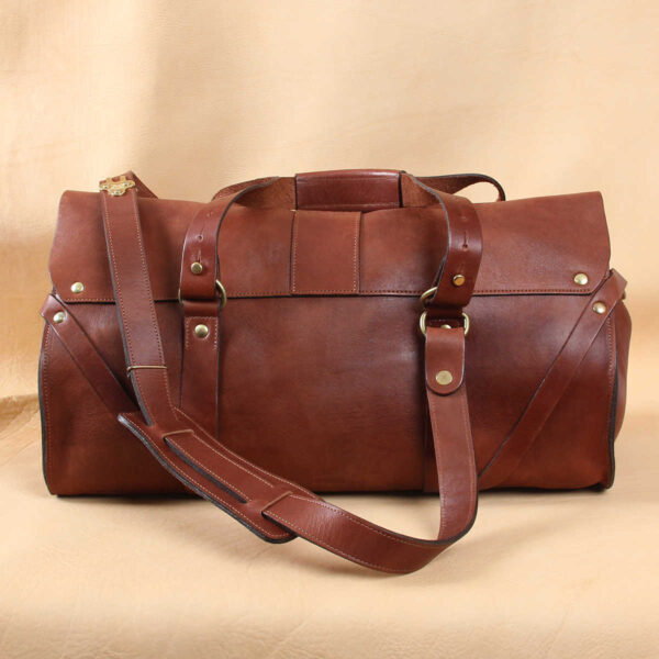 leather travel bag back side plain with brown leather carry strap.