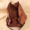 leather travel bag open wide to show inside suede lining.
