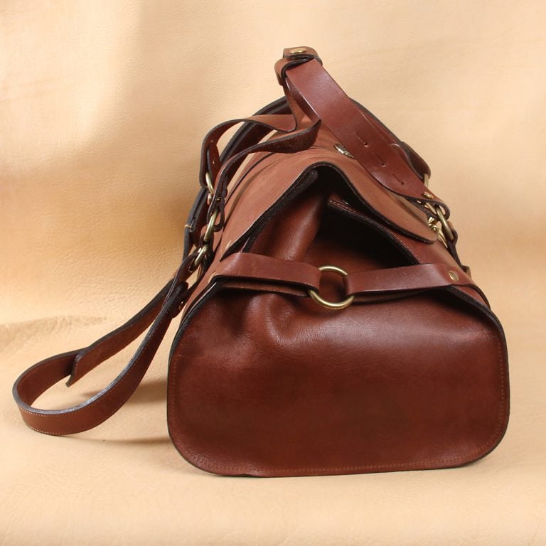 leather travel bag side strap with o-ring in center.